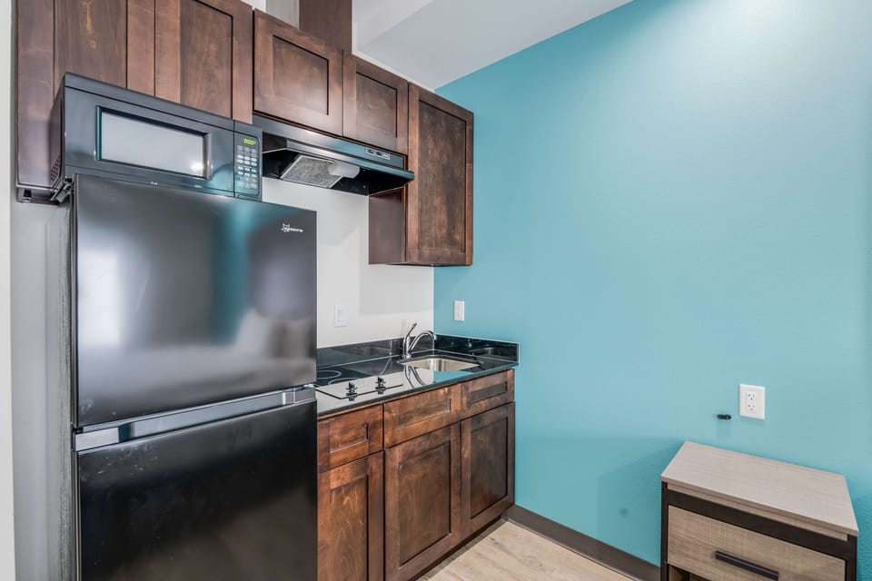 Cook light meals with a fridge, cooktop, and deep sink.