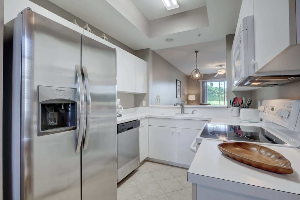 The Kitchen of the Condo Has Lots of Lighting