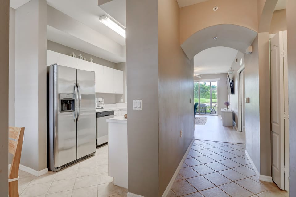 Upon Entering the Condo, Guests Come Into the Main Hallway With the Kitchen to the Left and the Second Bedroom to the RIght
