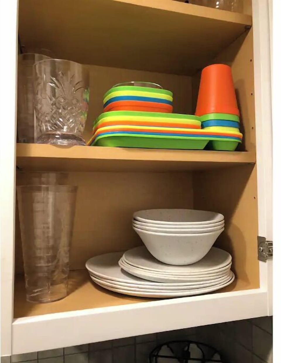 Kitchenette with plates, cups, wine glasses, and kids utensils and plates