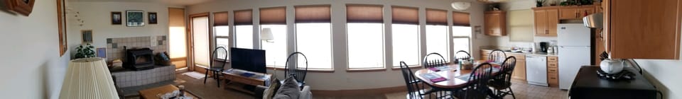PANORMIC VIEW OF LIVING ROOM LEFT AND DINING ROOM RIGHT WINDOWS TO THE OCEAN