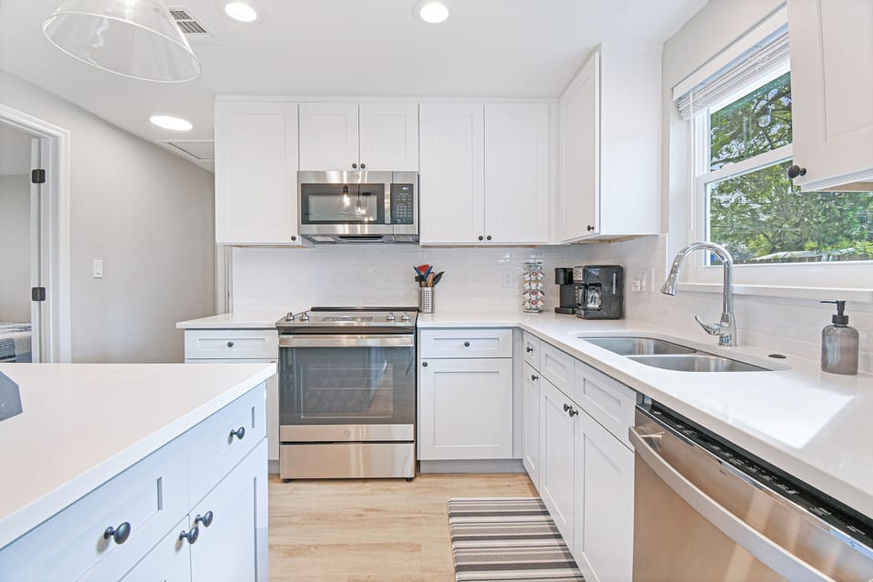 Fully stocked kitchen w/ all your cooking needs plus an island w/ seating for 3