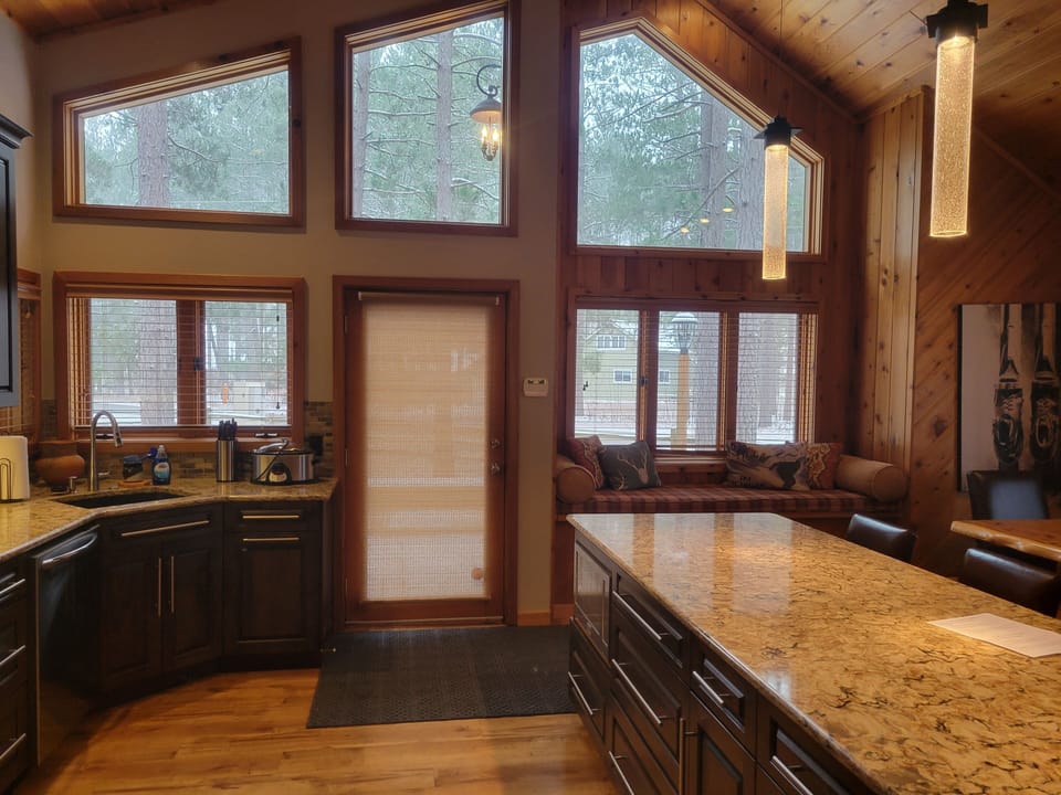 View of kitchen and window seat from hallway.
