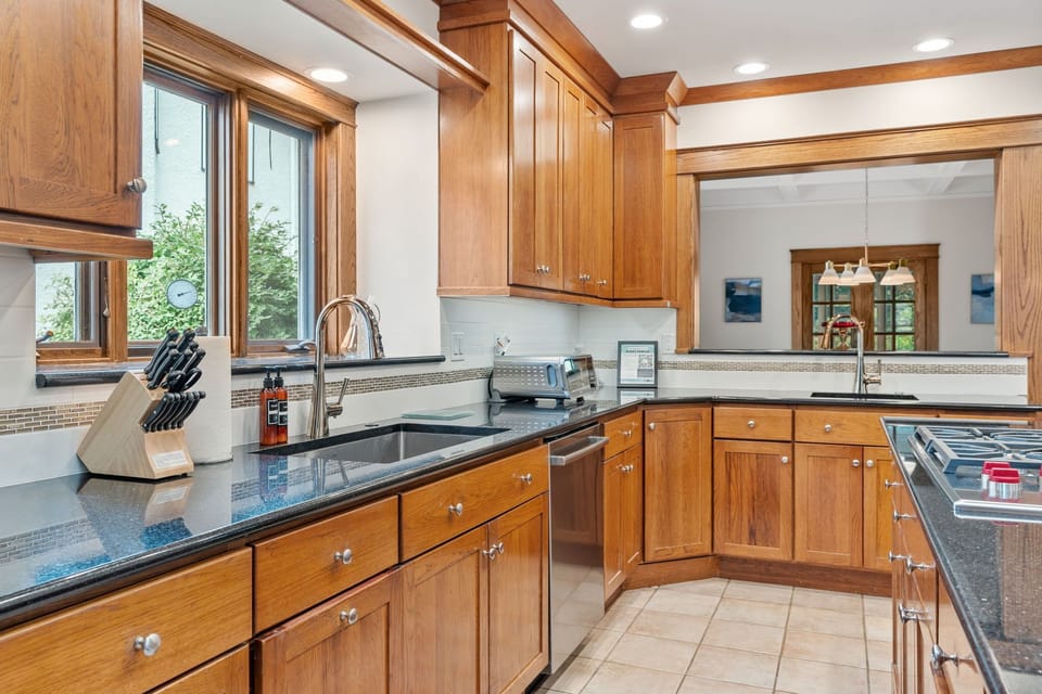 Your gourmet kitchen features rich wood cabinetry, granite countertops, and premium appliances for memorable meals.