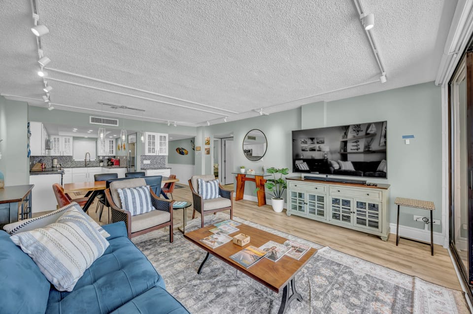 Sink into plush seating and unwind in this bright, open living space where coastal charm meets modern comfort—your perfect home base for relaxation and connection.