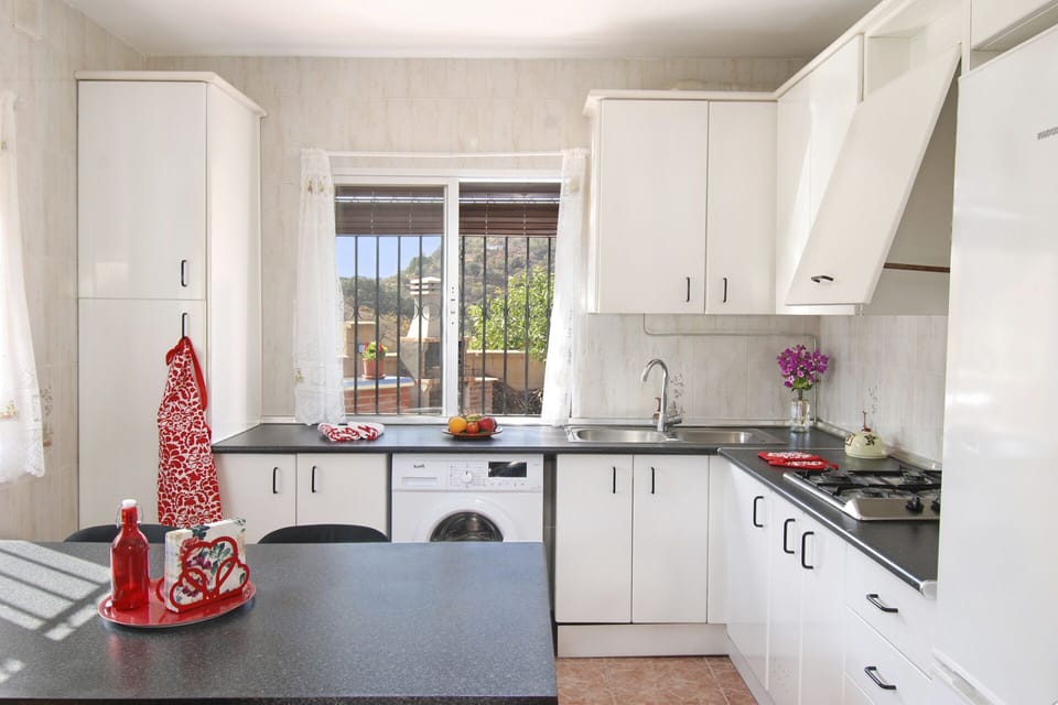 There is a washing machine, double sink, fridge freezer, microwave and ...view.