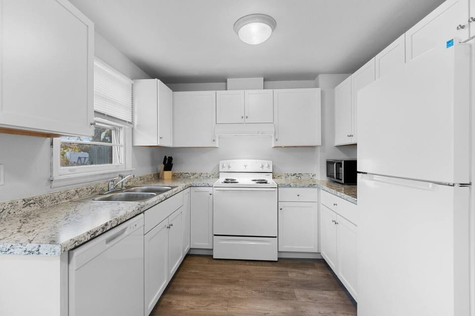 Fully furnished kitchen with dining area seating.