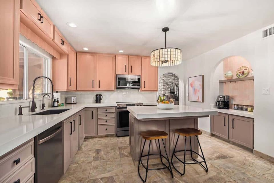 Large, fully stocked chef's kitchen with island seating and coffee bar