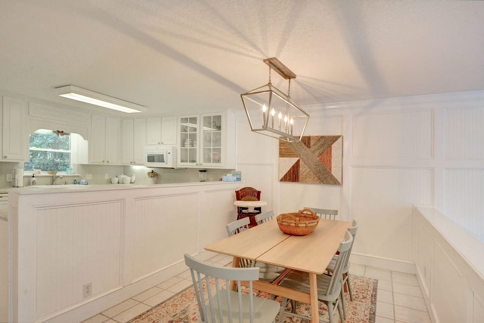 Dining Room – Alternate View with Natural Light - Alternate view of the dining area showing natural light, coastal textures, and layout flow into the living room. Bright, welcoming, and designed for easy meals with the whole crew.