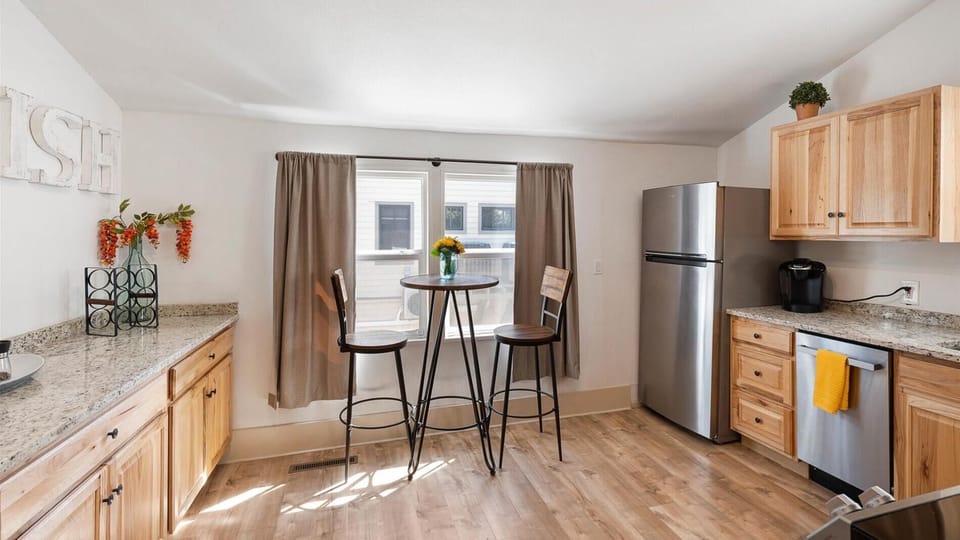 The large kitchen is fully stocked with cookware and top of the line appliances. The kitchen also features a cozy coffee nook with seating for two.