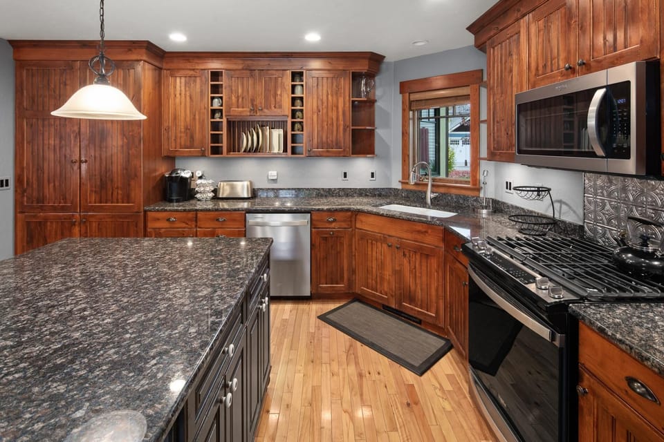 The open concept kitchen fully stocked with cookware, state of the art appliances, and more!