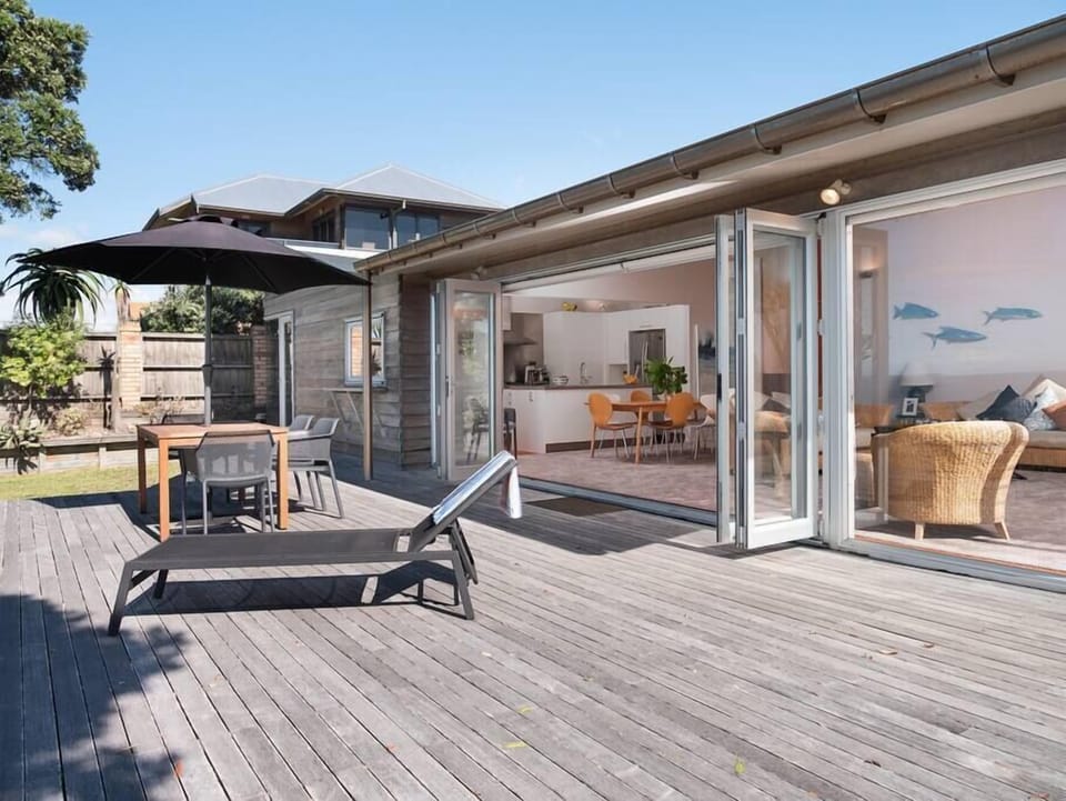 Large bifolds connect the deck and open plan living