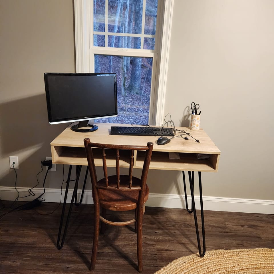 King bedroom with adjustable base bed, chifferobe storage and office space.