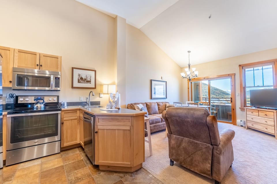 Relax in your spacious open-plan suite with full kitchen, cozy living area, and stunning mountain views from your private balcony.