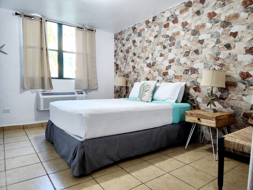 Master bedroom with queen bed and bathroom.