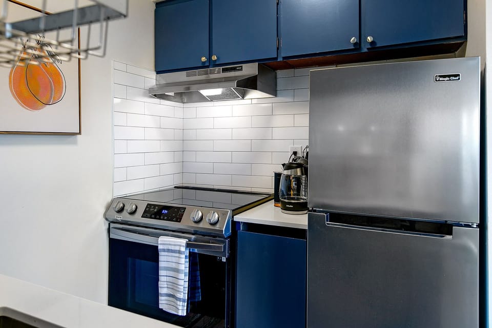 Kitchen with full size range and refrigerator. 