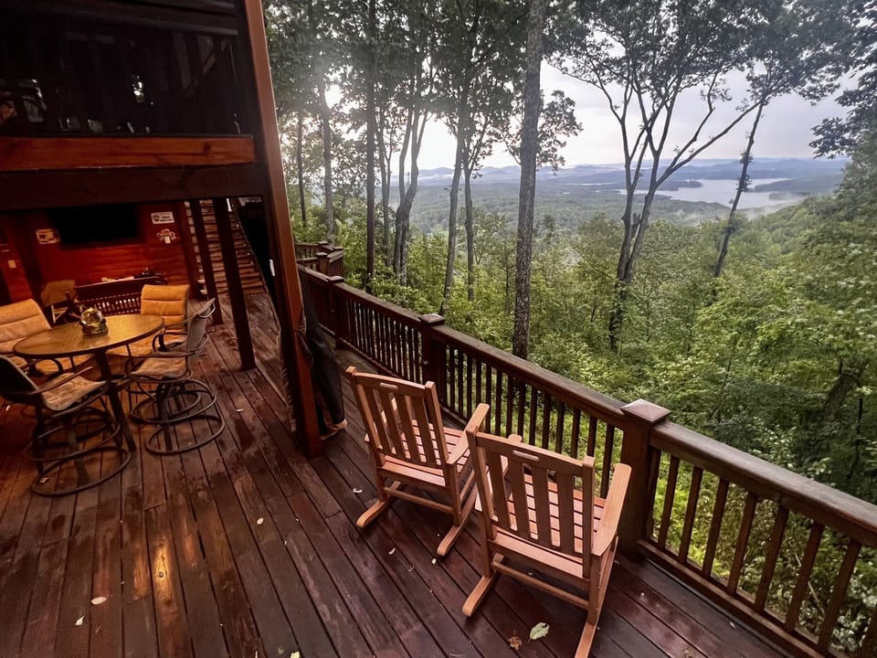 One of several outdoor seating options overlooking layered mountain and lake views
