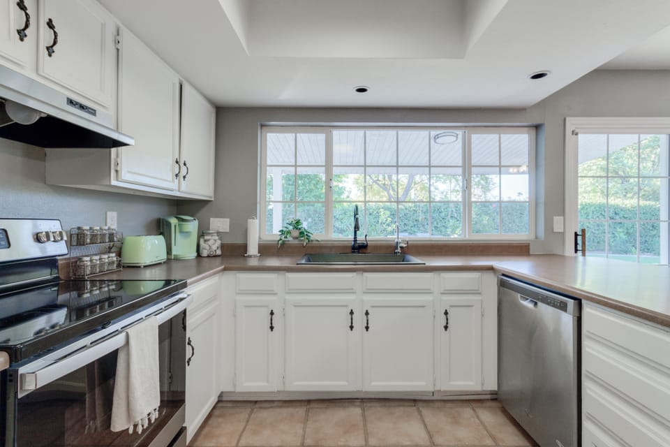 Kitchen is stocked with dishes, utensils, spices and coffee!