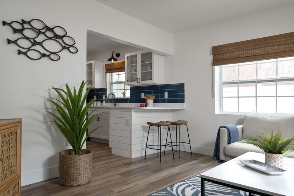 Kitchen leading from living room with counter seating for 2  