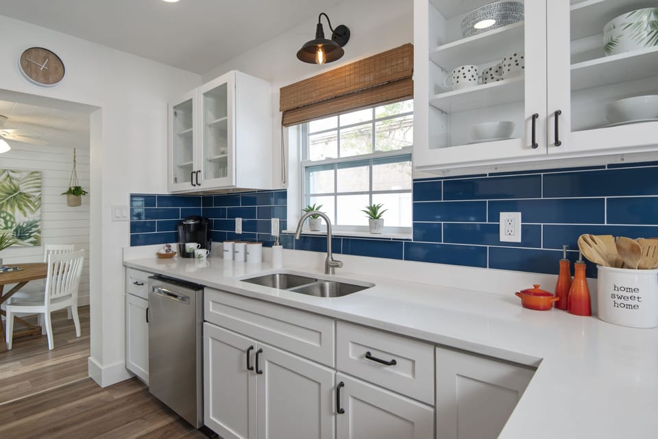 Fully equipped kitchen with new appliances and window overlooking side patio