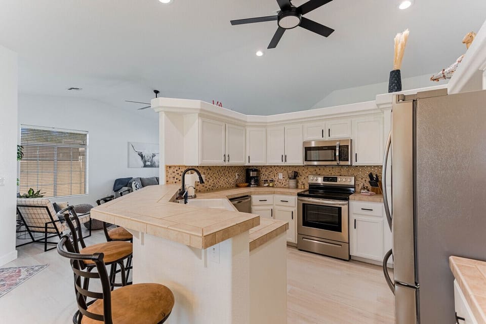 Fully stocked kitchen with modern appliances and all essentials for cooking and dining.