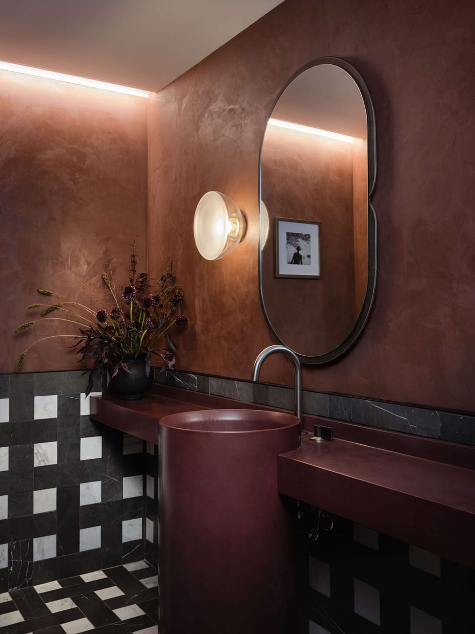 Freshen up at the dramatic vanity with warm ambient glow.