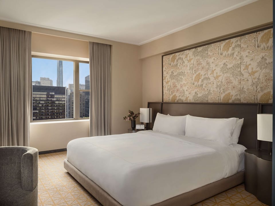 Unwind in a crisp king bed with skyline views.