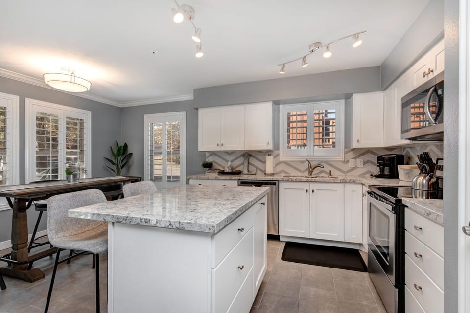 Step into your bright, modern kitchen featuring gleaming granite counters, stainless steel appliances, and a spacious island perfect for gathering with friends and family.