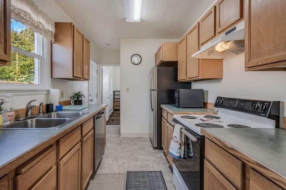 Your fully equipped galley kitchen features warm wood cabinets, modern appliances, and everything you need to prepare meals during your stay.