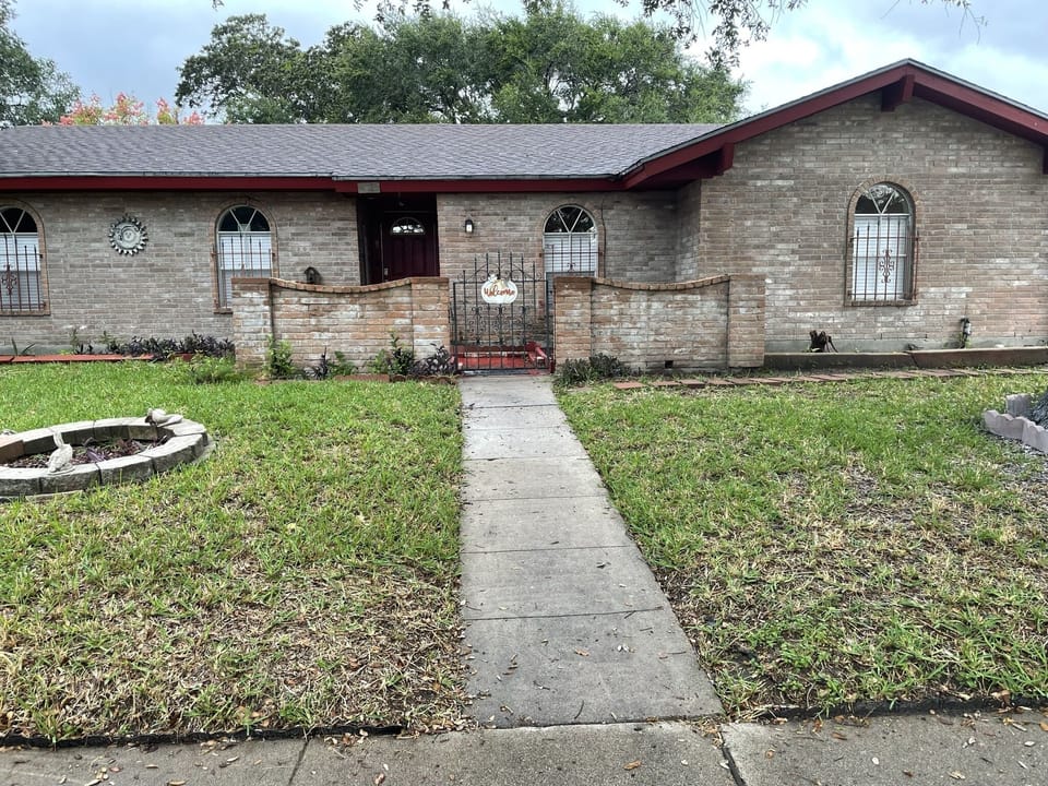 Front of house - closer view with front gate into porch and sitting area.
