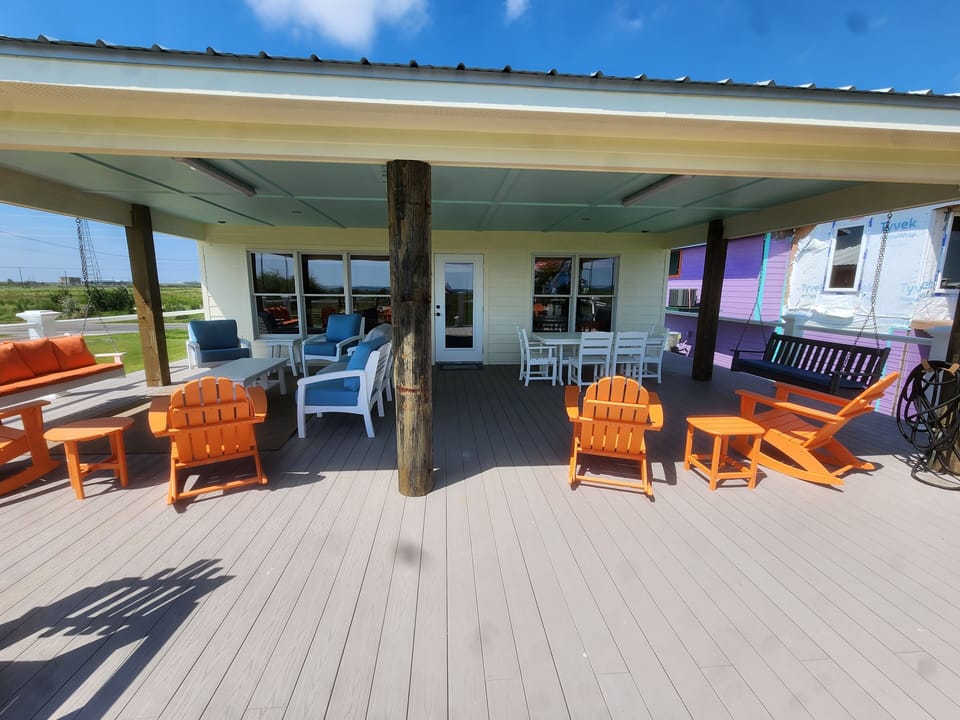 Partially covered back deck with beach view. With all the sitting area you need.