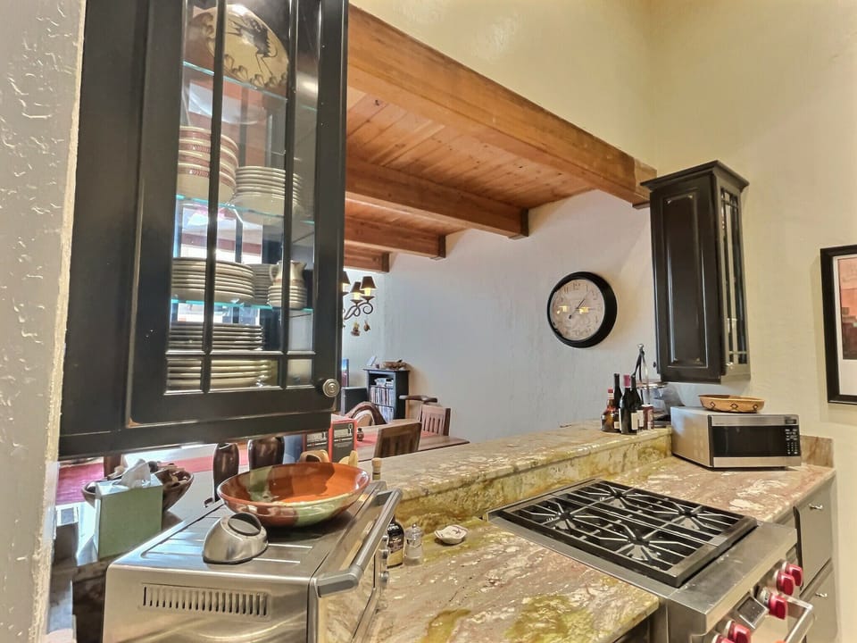 Kitchen tools and appliances for easy meals at home and a view of the living and dining areas, ask us about our in home chef