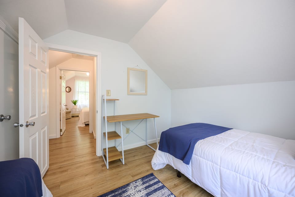 2nd Floor Bedroom with 2 beds and small desk.
