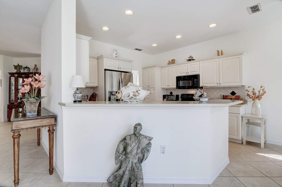 There is a Bar Height Counter From the Kitchen To the Family Room and The Breakfast Nook Dining Area