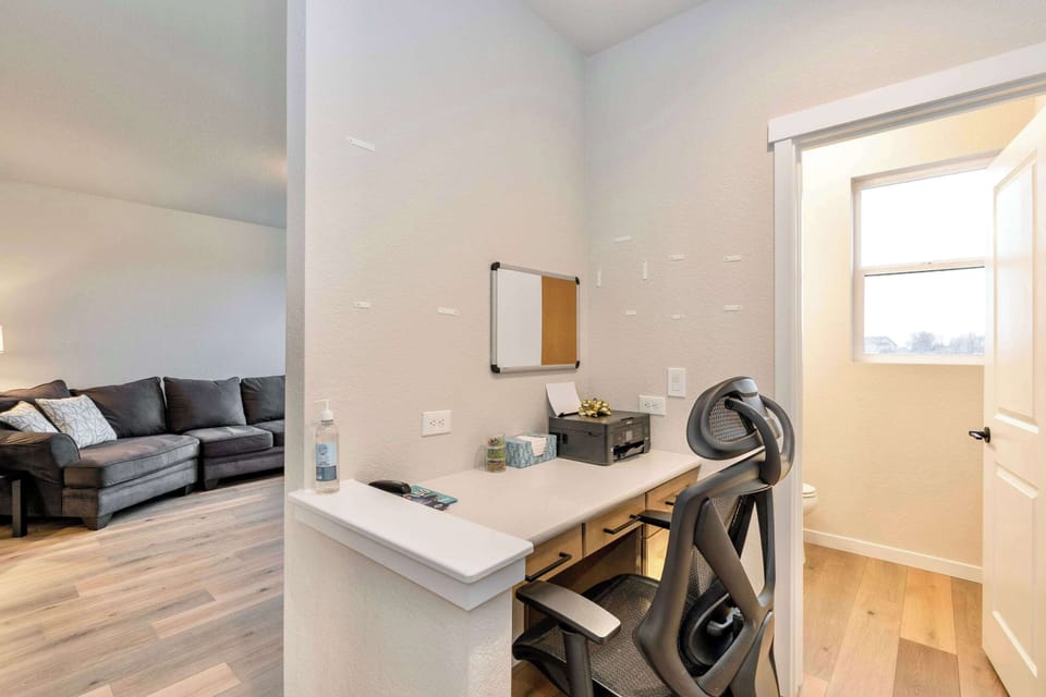 Bright and Spacious Home Office Setup works remotely in comfort with well-lit desk space. perfect for digital nomads