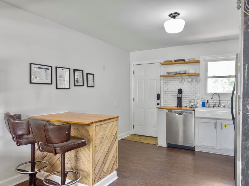 The kitchen is full stocked for your stay. Small dining area at custom built bar