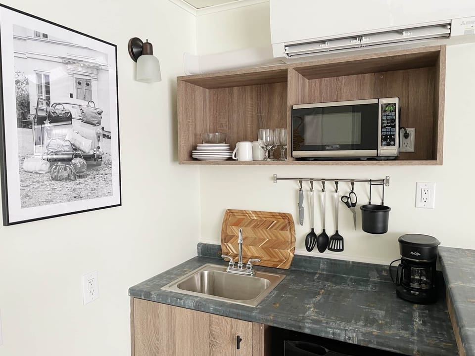 Wet bar, small refrigerator, microwave, sink, and most importantly a coffee maker.