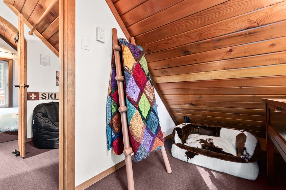 To the right of the beanbags, the first Queen bedroom has a small sitting area...