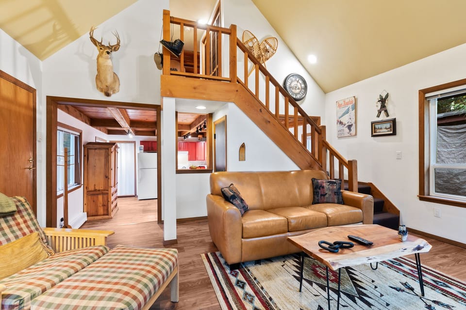 Stairs to the bedroom and comfy-cozy couches