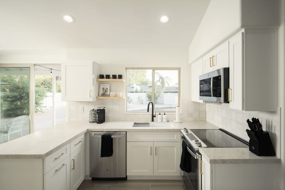 Fully stocked kitchen with stainless steel appliances, electric stovetop