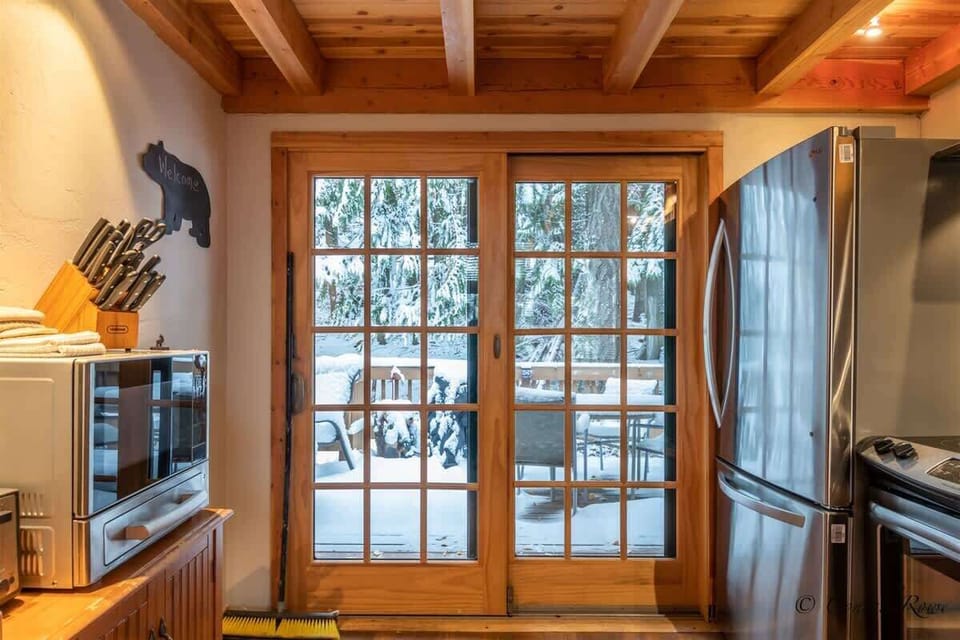 Sliding Glass Doors in the Kitchen, Leading to the Back Deck with a BBQ Grill