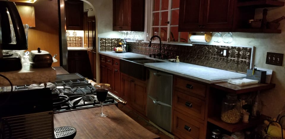 Kitchen with marble counter tops, Le Cornufe oven, wine fridge, Nespresso coffee