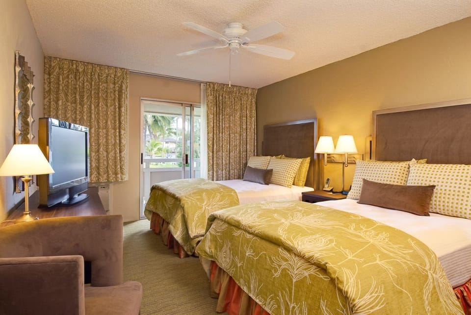 Unwind in twin beds with balcony breeze and warm lighting.
