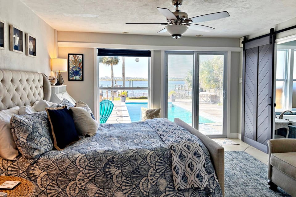 Primary bedroom boasts spectacular views of the river w/ private entrance/exit to pool deck, a Queen size bed...