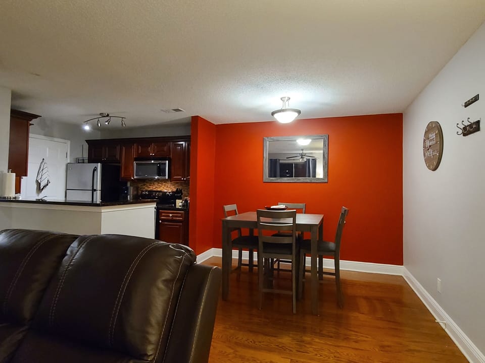 stovetop, refrigerator, living area, indoor, microwave, dining table, kitchen 