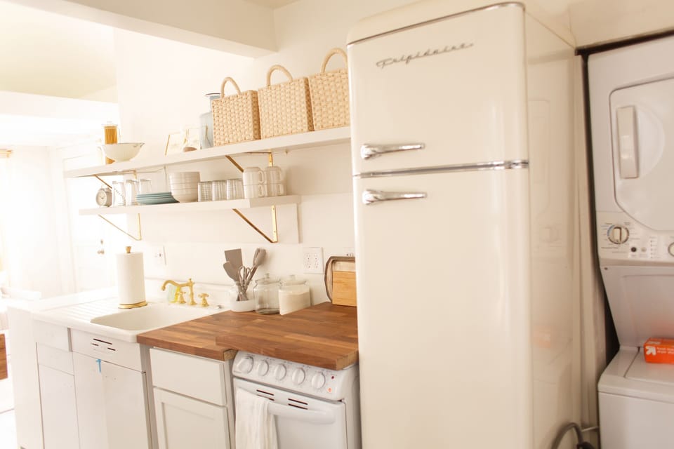 Kitchen has fridge, oven, & stovetop (covered by removable butcher block)