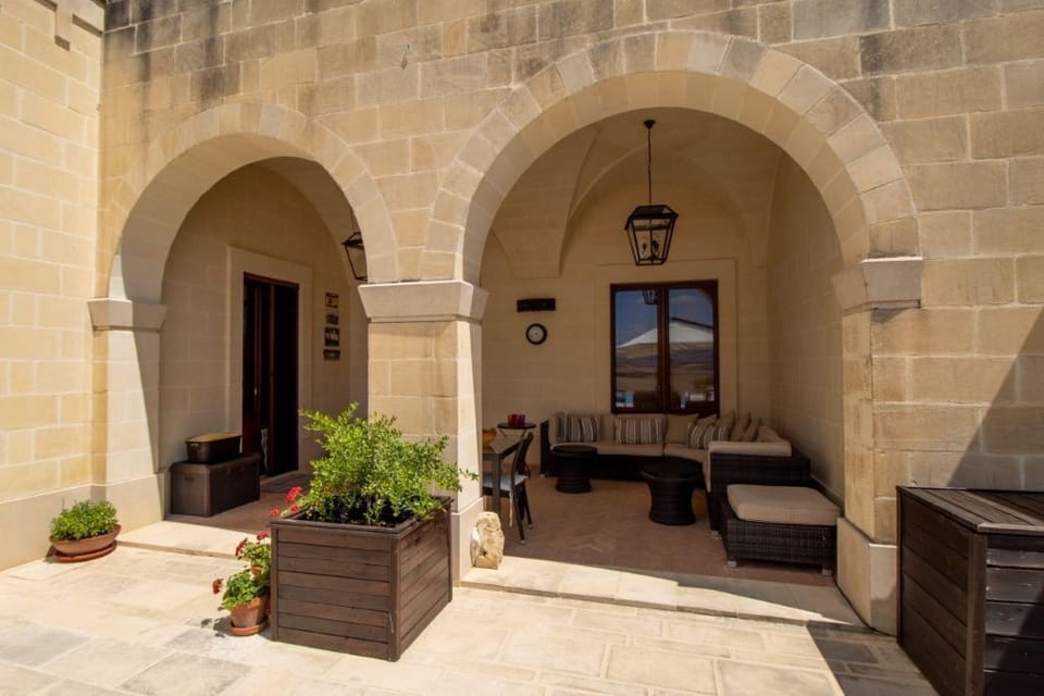 Outdoor dining are with vaulted ceilings and pool views.