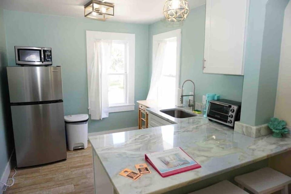 Kitchen with all cooking utensils, portable dining table, 2 burner cooktop, microwave, toaster oven and full size sink!