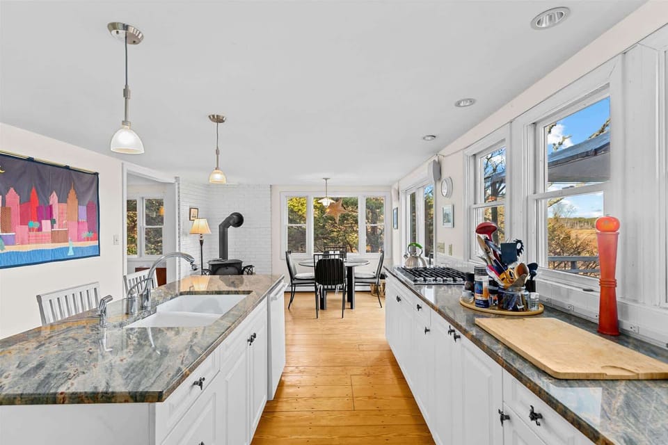 The kitchen features abundant counterspace in a bright white setting, perfect for vacation cooking.