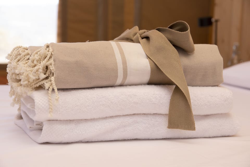 Premium linens and plush high-quality cotton towels enhance the experience in our luxury lodge. Soft textures and refined details reflect exceptional comfort and thoughtful hospitality. Every element is designed to deliver an upscale wilderness stay where elegance, wellness, and relaxation come together in a sophisticated setting.